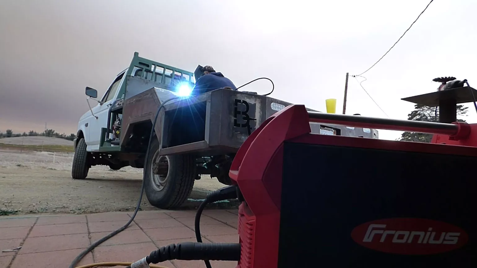 David Blackburn welding at a car